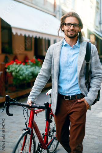 Stylish Man With Bicycle Going To Work On Street. © puhhha