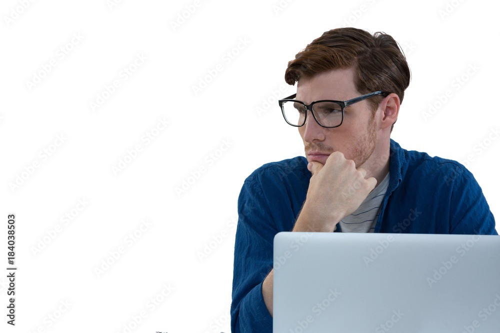 Thoughtful male executive using laptop