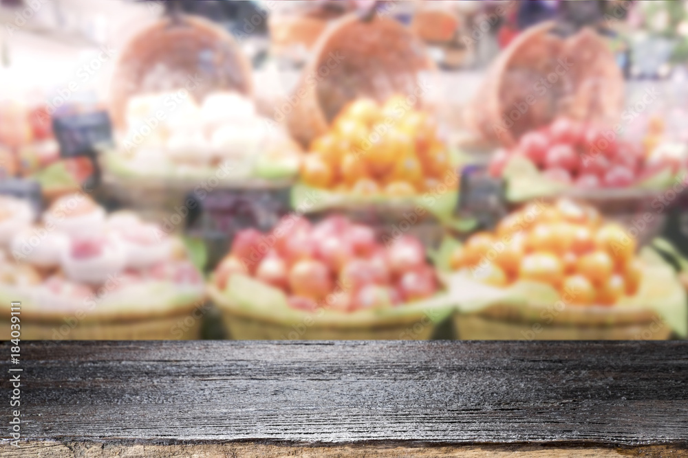 Wood table top on fruit store background. Wood table top on fruit store background.