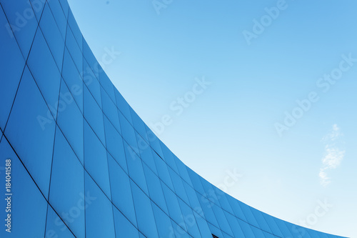 Corporate building on the blue sky background with isolated place for text