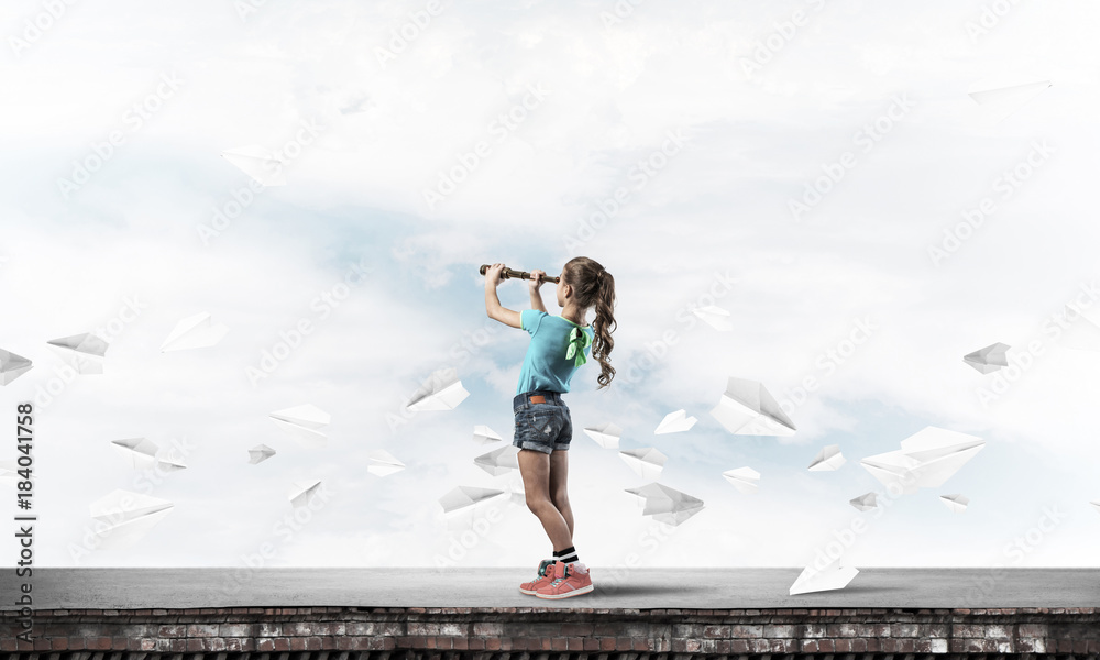 Concept of careless happy childhood with girl exploring this wor Concept of careless happy childhood with girl exploring this wor