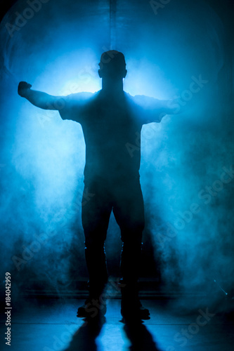 Silhouette of a man in fog blue light
