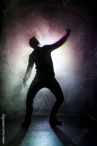 Silhouette of a dancer man in the light