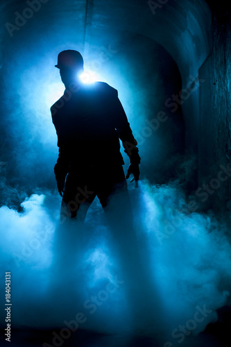 Silhouette of a dancer man in the light