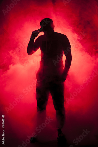 Silhouette of a man in fog red light