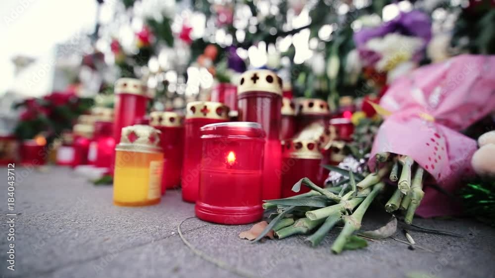 Candles and flowers on the sidewalk to comemorate a famous dead person Candles and flowers on the sidewalk to comemorate a famous dead person