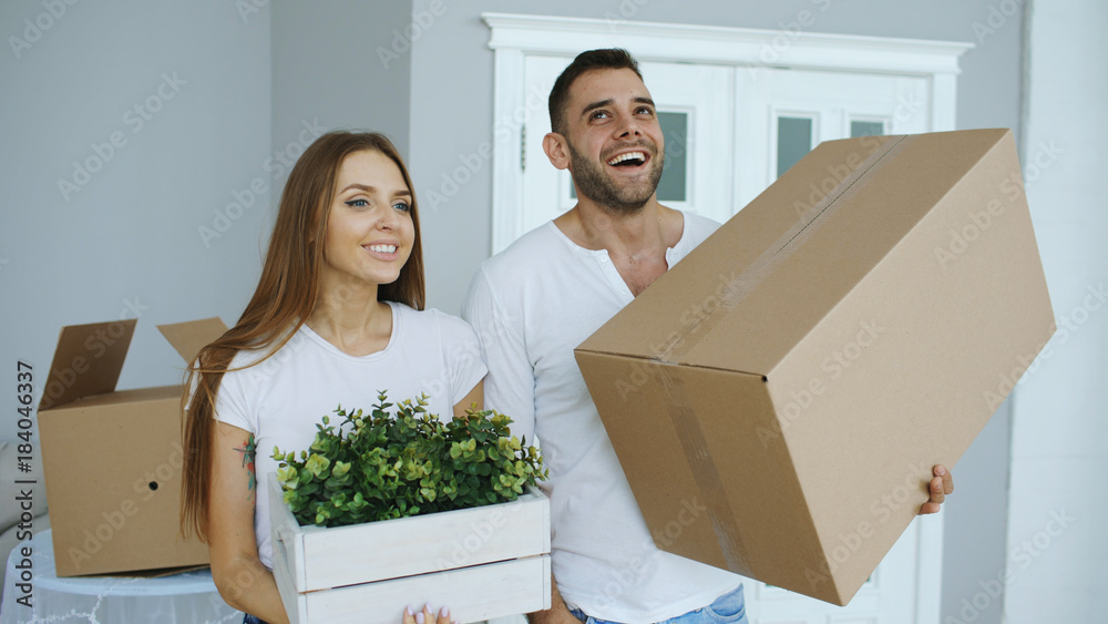 Young happy couple talking while standing at their new house