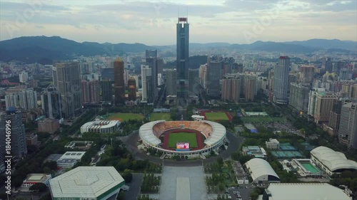 evening time tianhe sports centre stadium guagzhou city aerial panorama 4k china
 photo