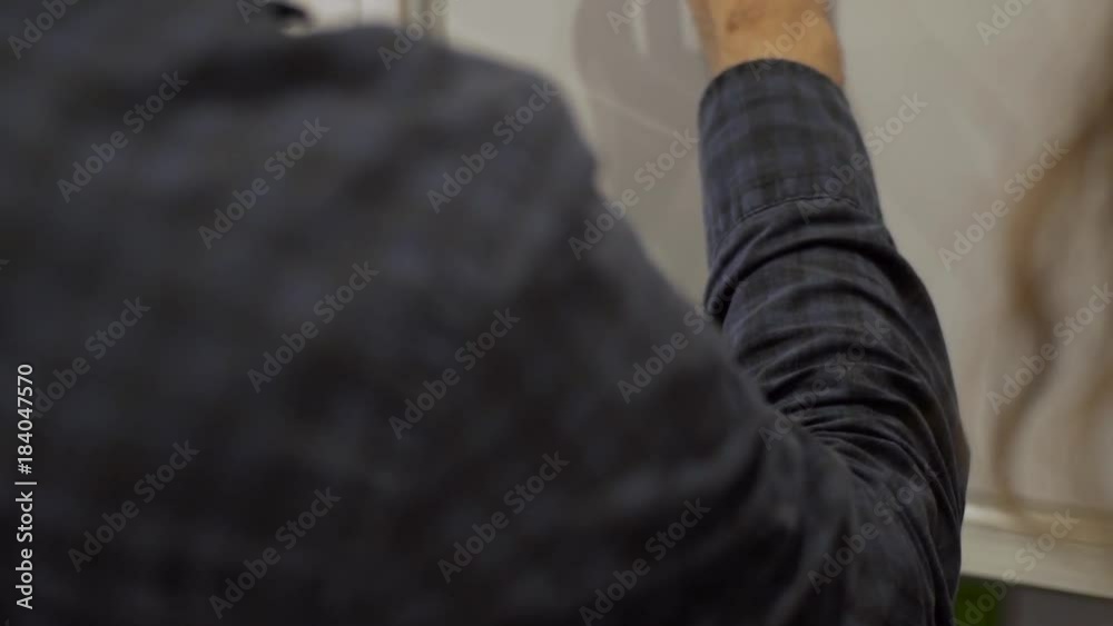 Close up shot of businessman writes data marker on white board Close up shot of businessman writes data marker on white board
