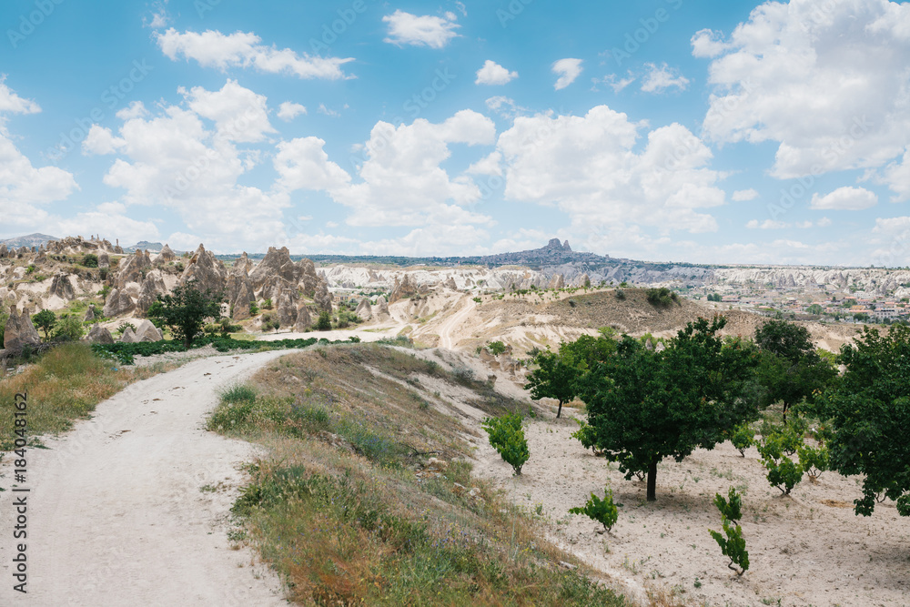 Beautiful view of the hills of Cappadocia. One of the sights of Turkey. A blue sky with clouds in the background.