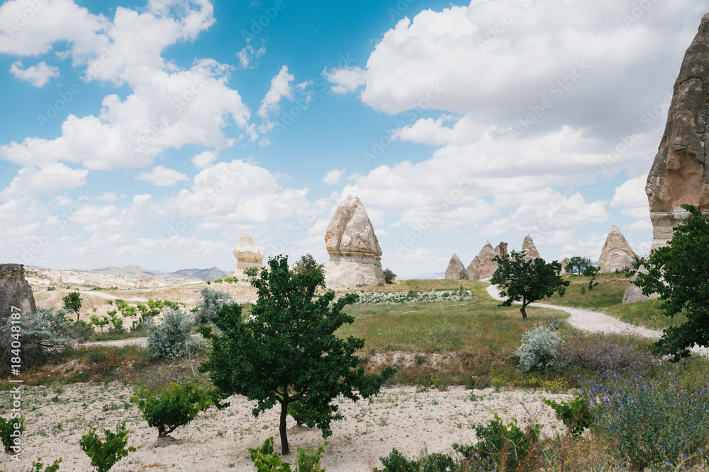 Beautiful view of the hills of Cappadocia. One of the sights of Turkey. A blue sky with clouds in the background.
