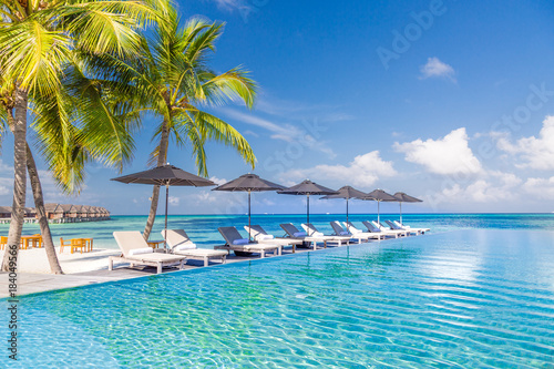 Fototapeta Naklejka Na Ścianę i Meble -  Luxury beach scene with sun chairs and loungers and the blue sea in the background in Maldives