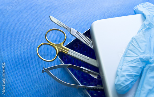 Basic surgical instruments in the sterilized blue wrap photo