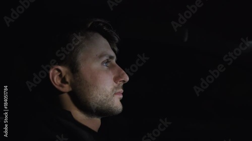 Profile of man's face while driving a car on the highway