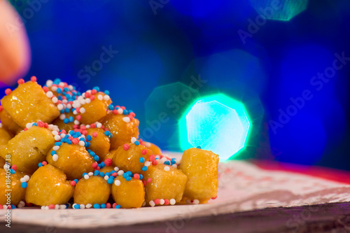 Close Up Of Italian Traditional Food Called Strufoli On Blur Colored Background