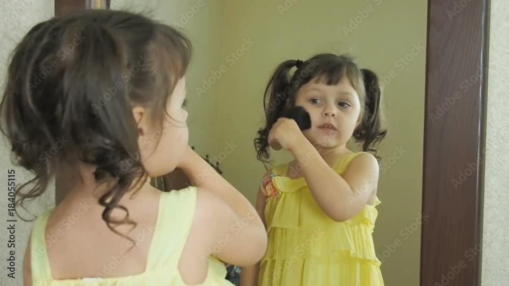 Little fashion-girl. Little girl at the mirror with women's cosmetics. Little fashion-girl. Little girl at the mirror with women's cosmetics.