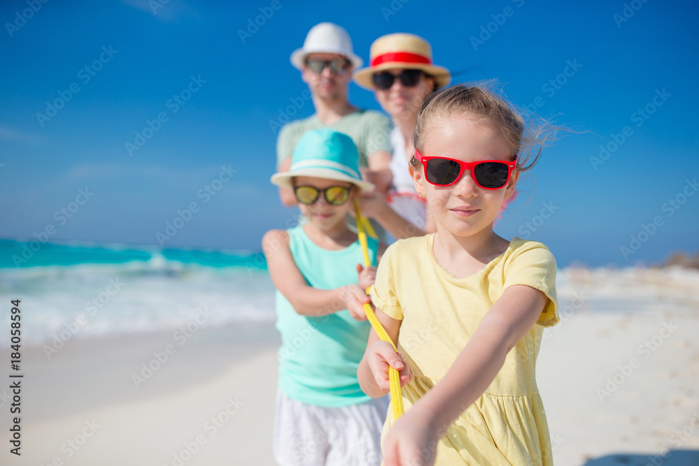 Happy family with two kids on the beach have a lot of fun Happy family with two kids on the beach have a lot of fun