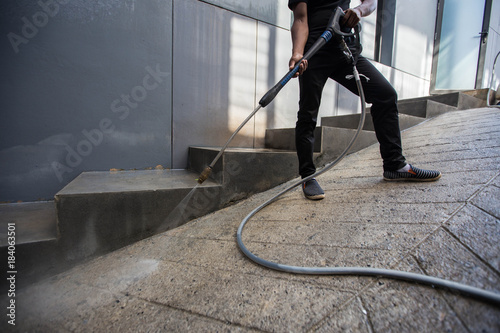 The man cleaning with high pressure water jet.