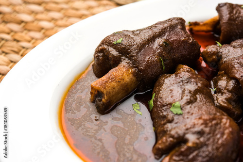 lamb shank or mutton or gosht paya or khoor curry served with indian bread or roti or naan

 photo
