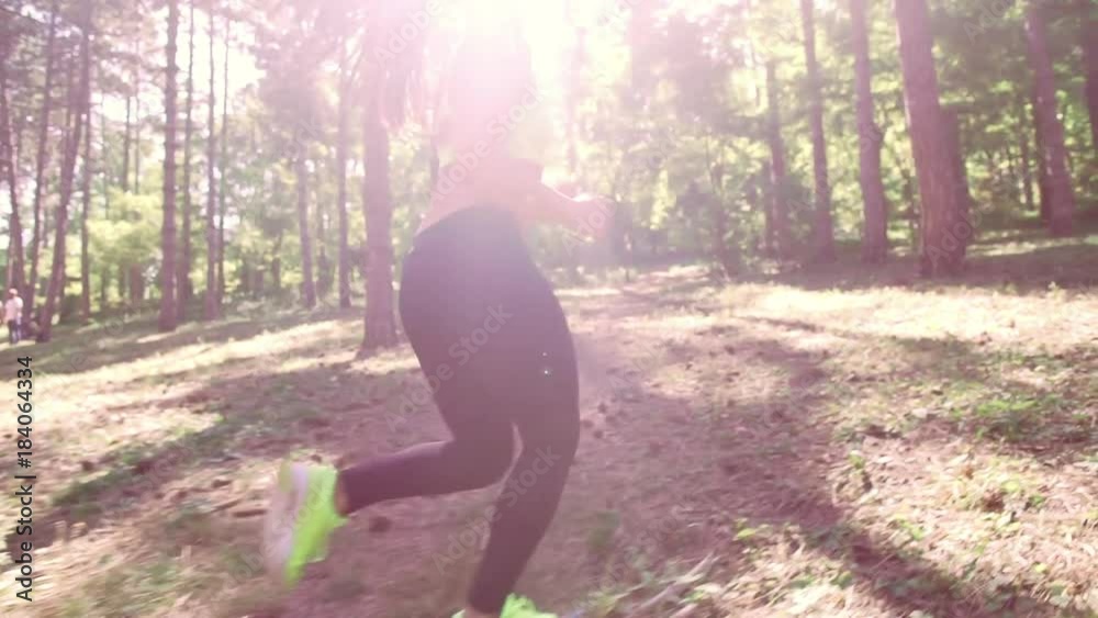 A girl jogging in the woods outdoors. Healthy lifestyle. A girl jogging in the woods outdoors. Healthy lifestyle.