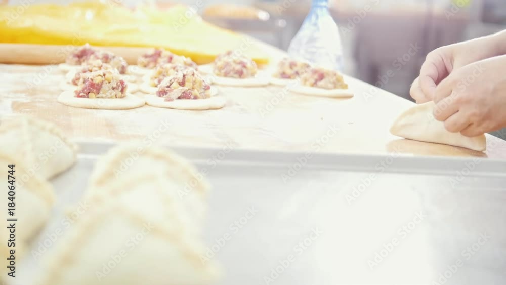 Cook bakes, forming and decorating pies in the bakery Cook bakes, forming and decorating pies in the bakery