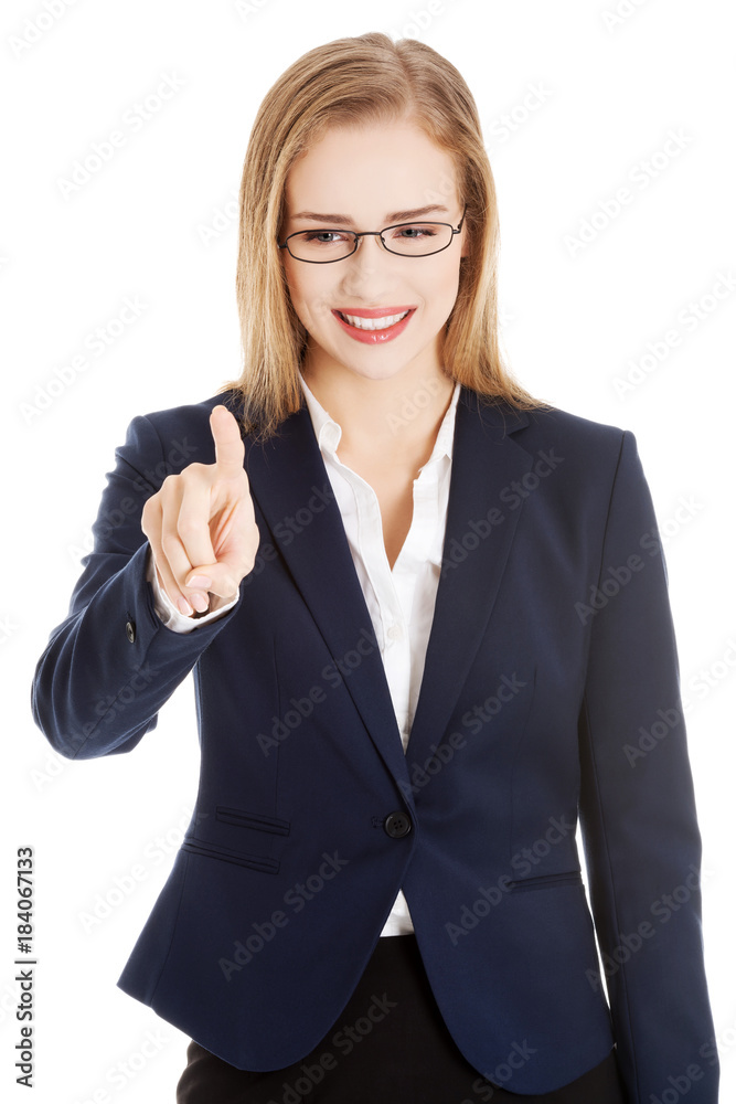 Beautiful caucasian business woman is pushing button on empty space. Beautiful caucasian business woman is pushing button on empty space.