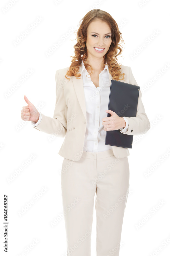 Businesswoman showing thumbs up with clipboard. Businesswoman showing thumbs up with clipboard.