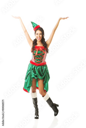 Full length woman with hands up wearing elf clothes