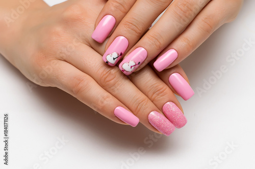 gently pink manicure with sparkles with painted hearts and arrows on square long nails
