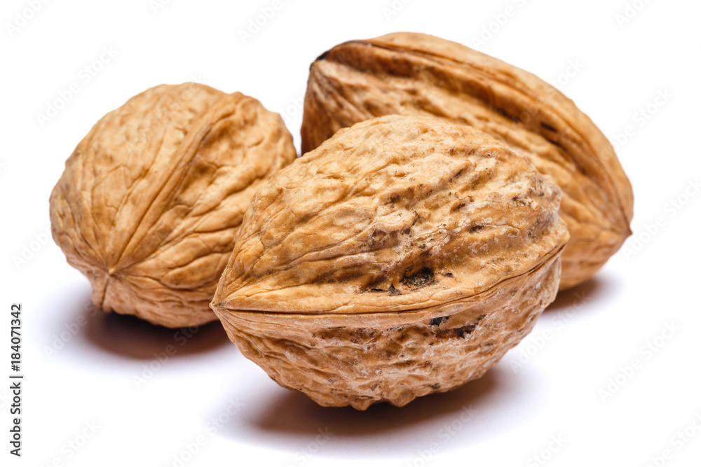 three whole walnuts isolated on white background. clipping path three whole walnuts isolated on white background. clipping path