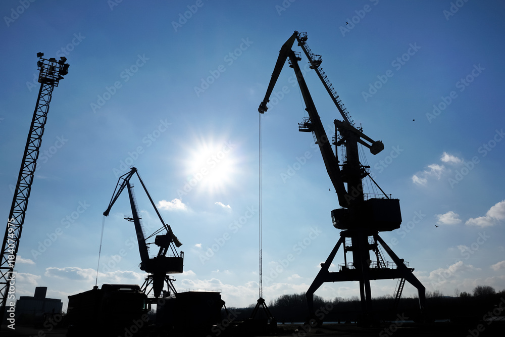 port crane silhuete with blue sky in background port crane silhuete with blue sky in background