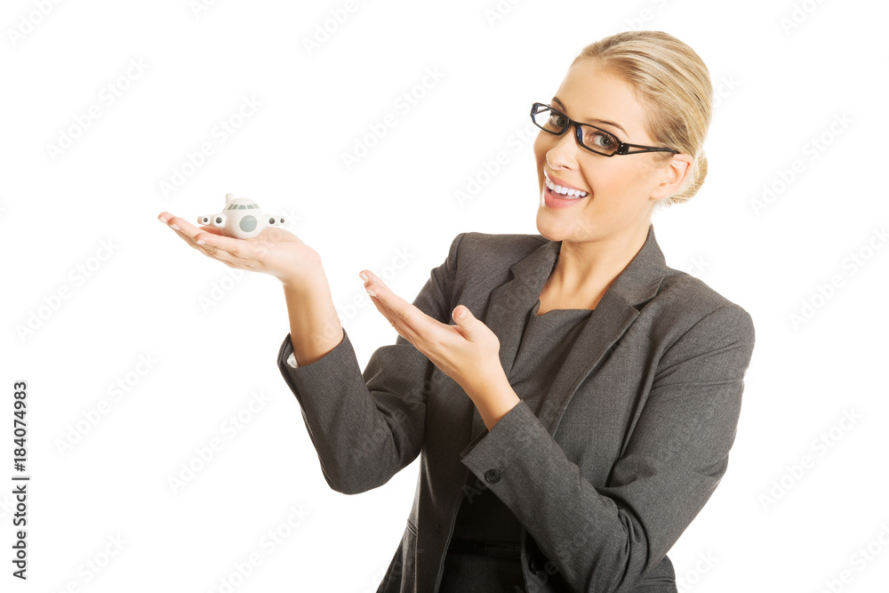 Businesswoman with plane toy in hand Businesswoman with plane toy in hand