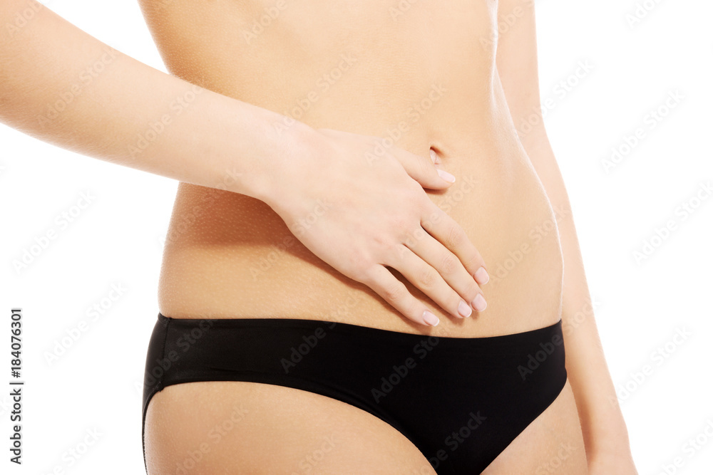 Caucasian woman is holding hand on her belly. Caucasian woman is holding hand on her belly.