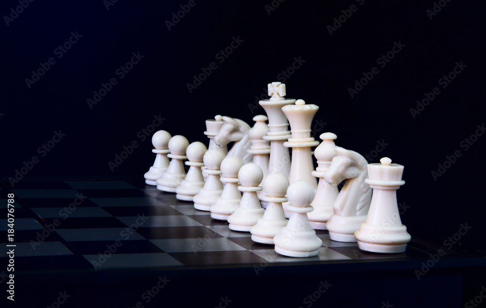 White chess figures on board. White chess set in order for game start.