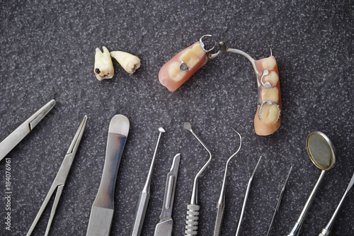 Tooth decay and false tooth with dentist's medical tools 