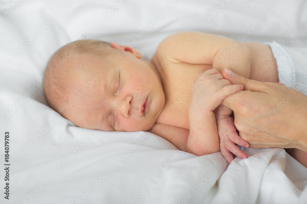 The newborn falls asleep in the mother's hands. The newborn falls asleep in the mother's hands.