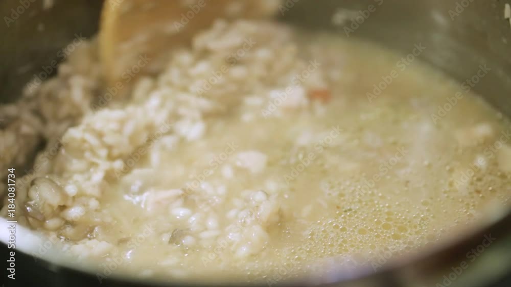 Stirring risotto in pan during cooking Stirring risotto in pan during cooking