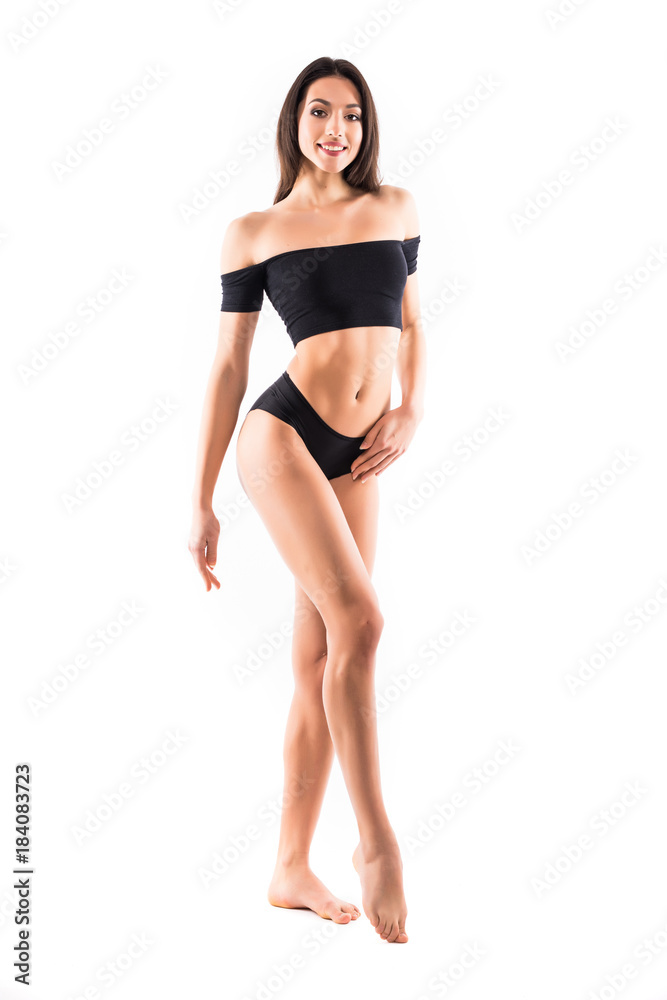 Young beautiful woman perfect body on white background in black sport clothes