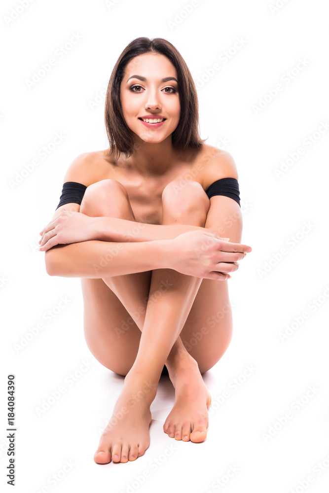 Fototapeta premium Beautiful slim body woman in good shape sport slim on floor posing isolated on white