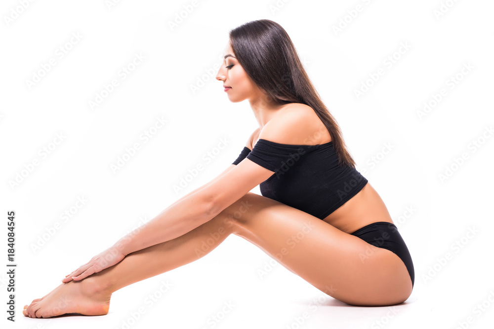Fit and sporty girl in black underwear. Beautiful and healthy woman posing over isolated white background. Sport, fitness, diet, weight loss and healthcare concept.