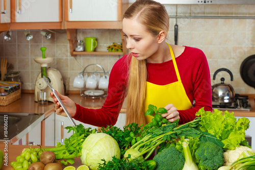 Woman having green vegetables thinking about cooking