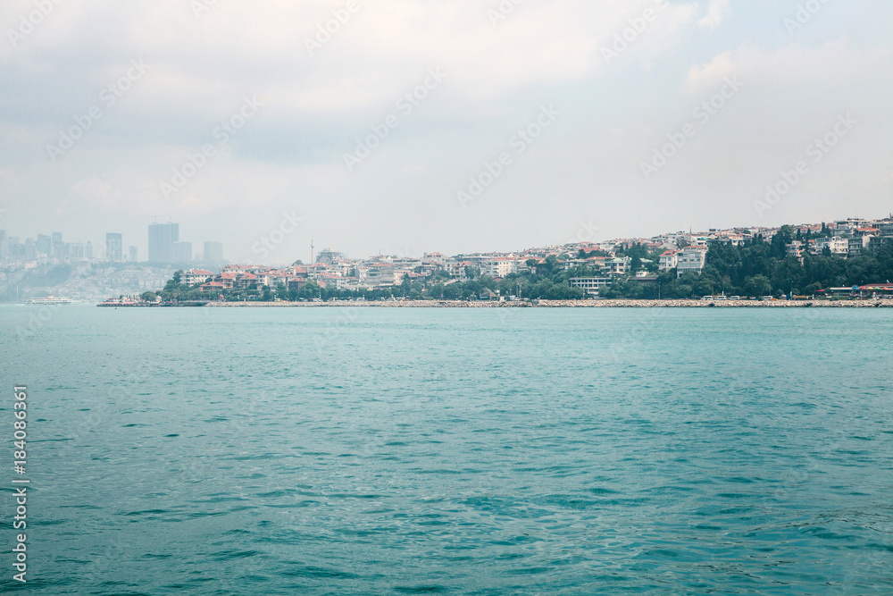 Amazing view of the European part of Istanbul against the beautiful blue Bosphorus and sky. Travel around Turkey.