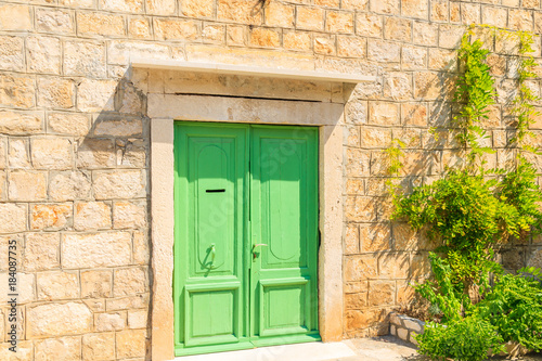 Green door of old house in Splitska village, Brac island, Croatia