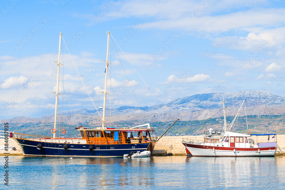 Sailing and fishing boats in Postira port, Brac island, Croatia Sailing and fishing boats in Postira port, Brac island, Croatia