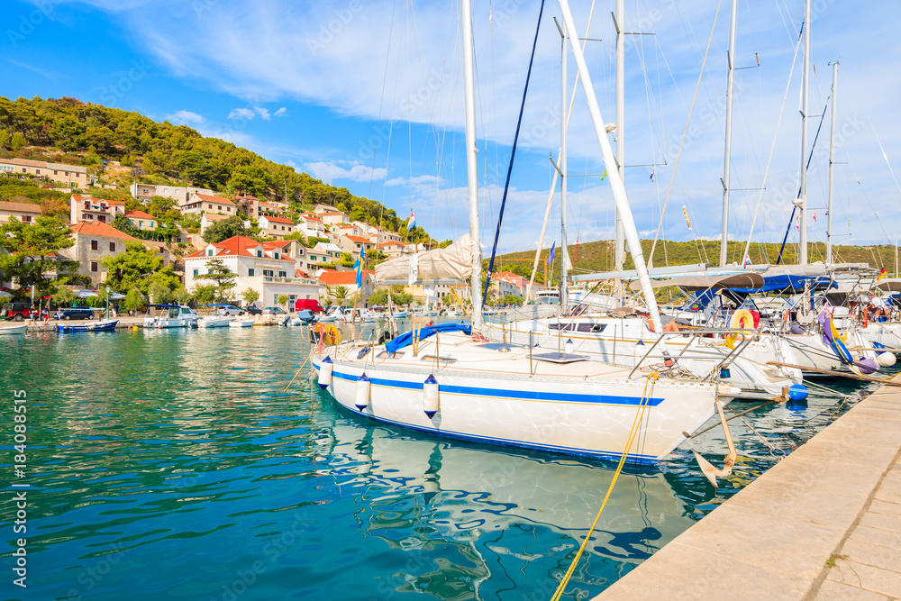 Sailing boats mooring in picturesque Pucisca port, Brac island, Croatia