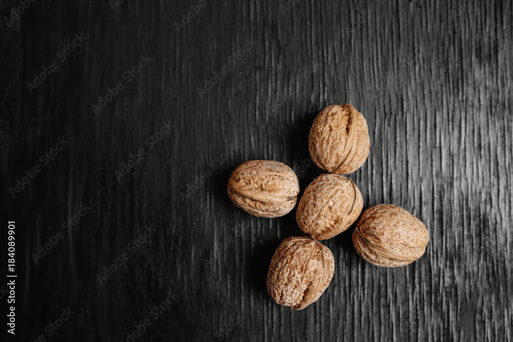 Lots of fresh nuts on a black wooden background. Best practices for designer. A beautiful design from the nuts Lots of fresh nuts on a black wooden background. Best practices for designer. A beautiful design from the nuts