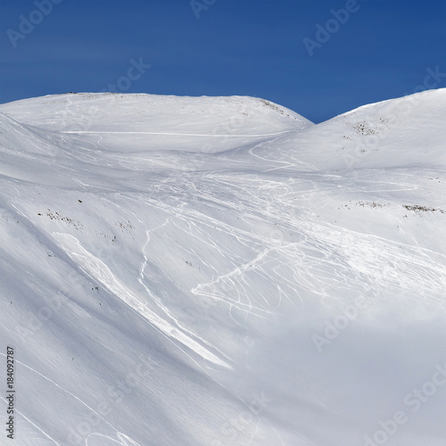 Snowy slope for freeriding with traces of skis, snowboards and avalanches © BSANI