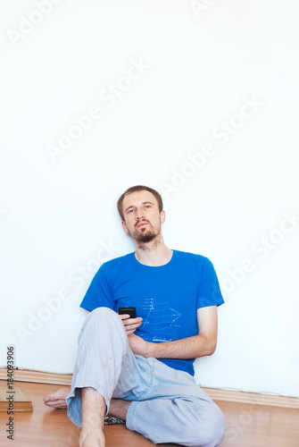 Handsome young man have fun at bright white wall background