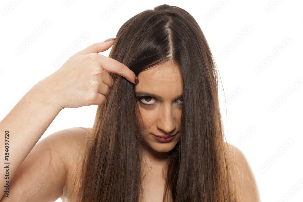 young beautiful woman peeking behind her hair young beautiful woman peeking behind her hair