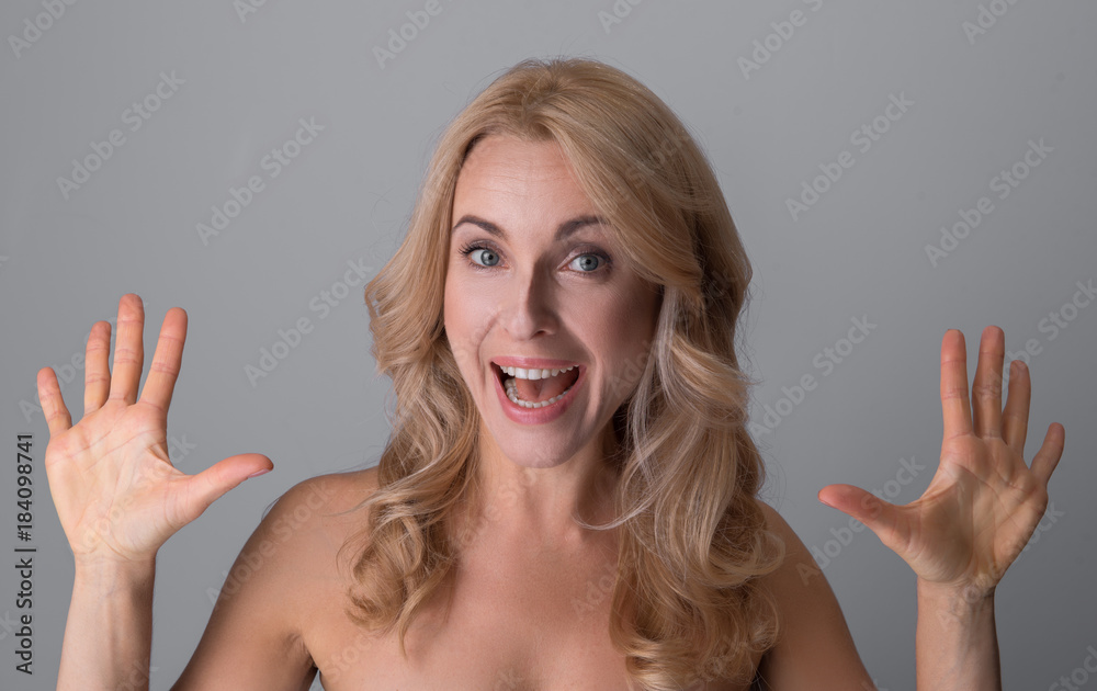 Sensation. Portrait of attractive overjoyed naked woman is standing with opened mouth and
